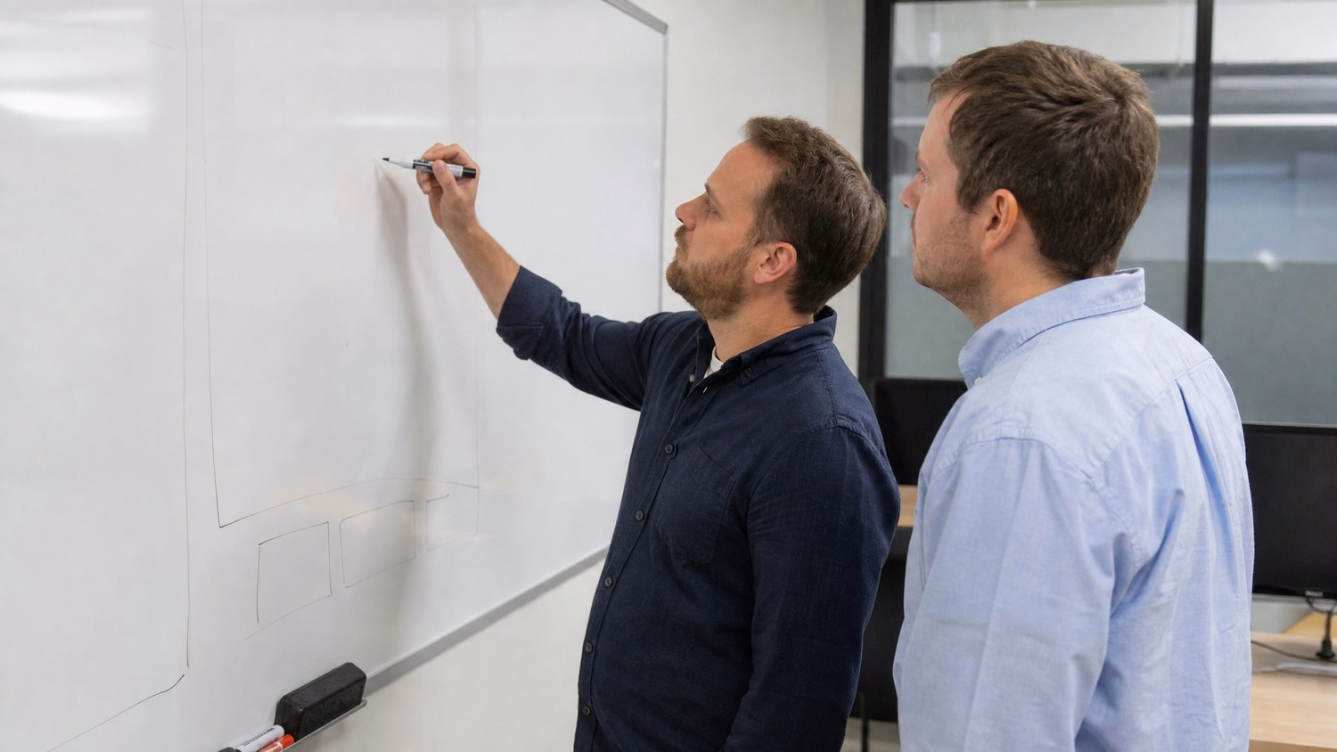 WHITEBOARD SESSION An IT professional one or two people standing at a whiteb