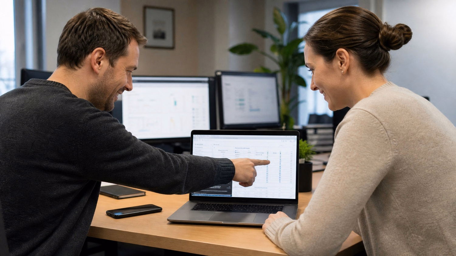 Man walks across office atrium holding tablet device