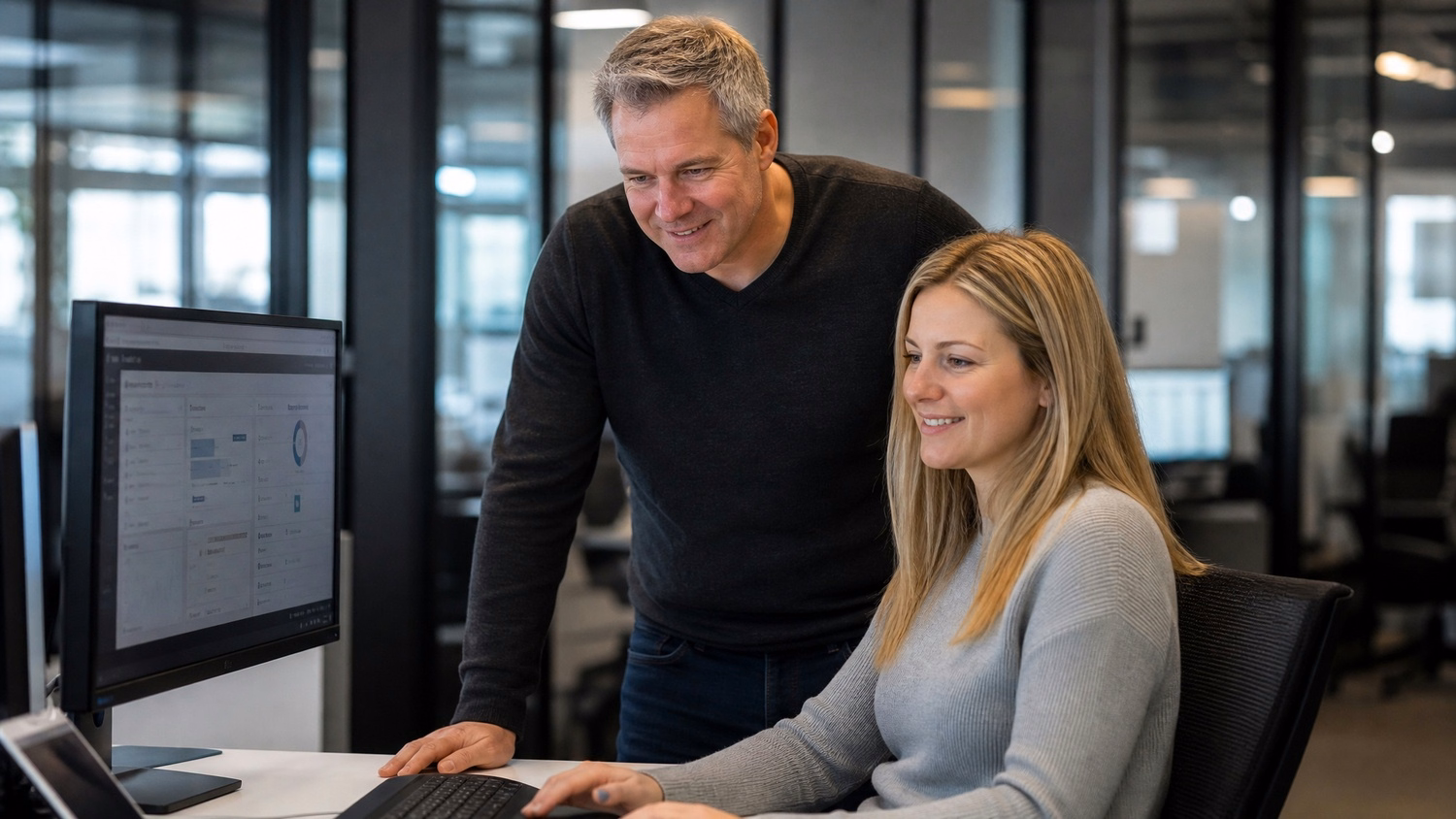 IT professionals reviewing dashboard on computer screen 60 chars