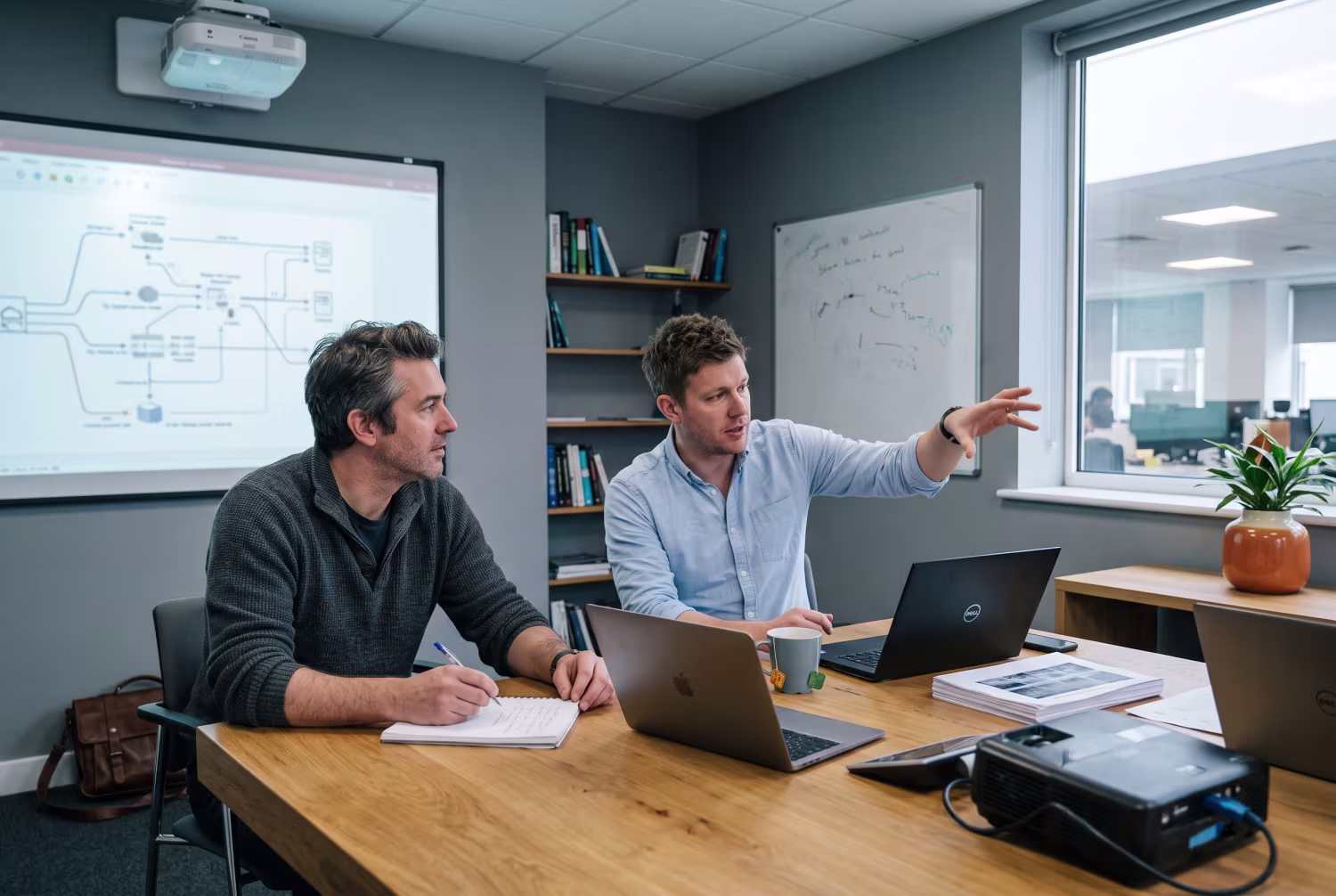 IT consultant explaining SIEM tuning to business owner
