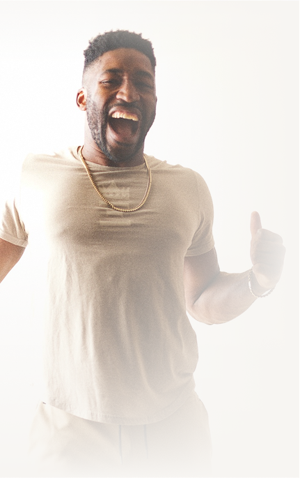 Meech wearing a t-shirt and gold chain giving an intense gesture.