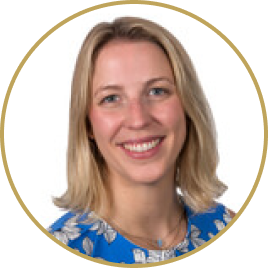 Smiling woman with shoulder-length blonde hair wearing a blue floral top.