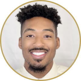 Smiling man with short curly hair and light facial hair wearing a white shirt, framed in a circular border.