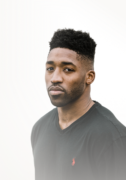 Portrait of Meech with short curly hair and a trimmed beard wearing a black V-neck shirt with a red logo.