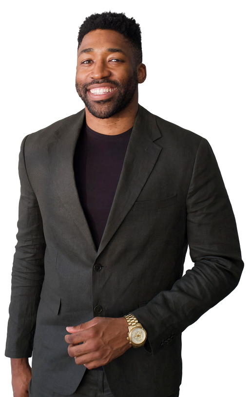 Meech Robinson (Meech) smiling in a dark blazer and black shirt wearing a gold wristwatch.