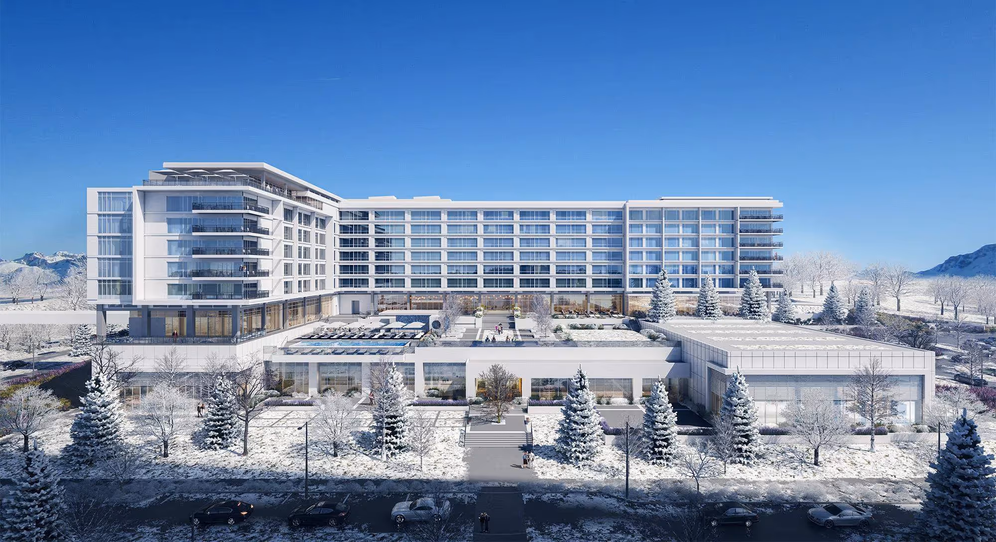 A big white building with glass panels sitting in the middle of a snowy place.