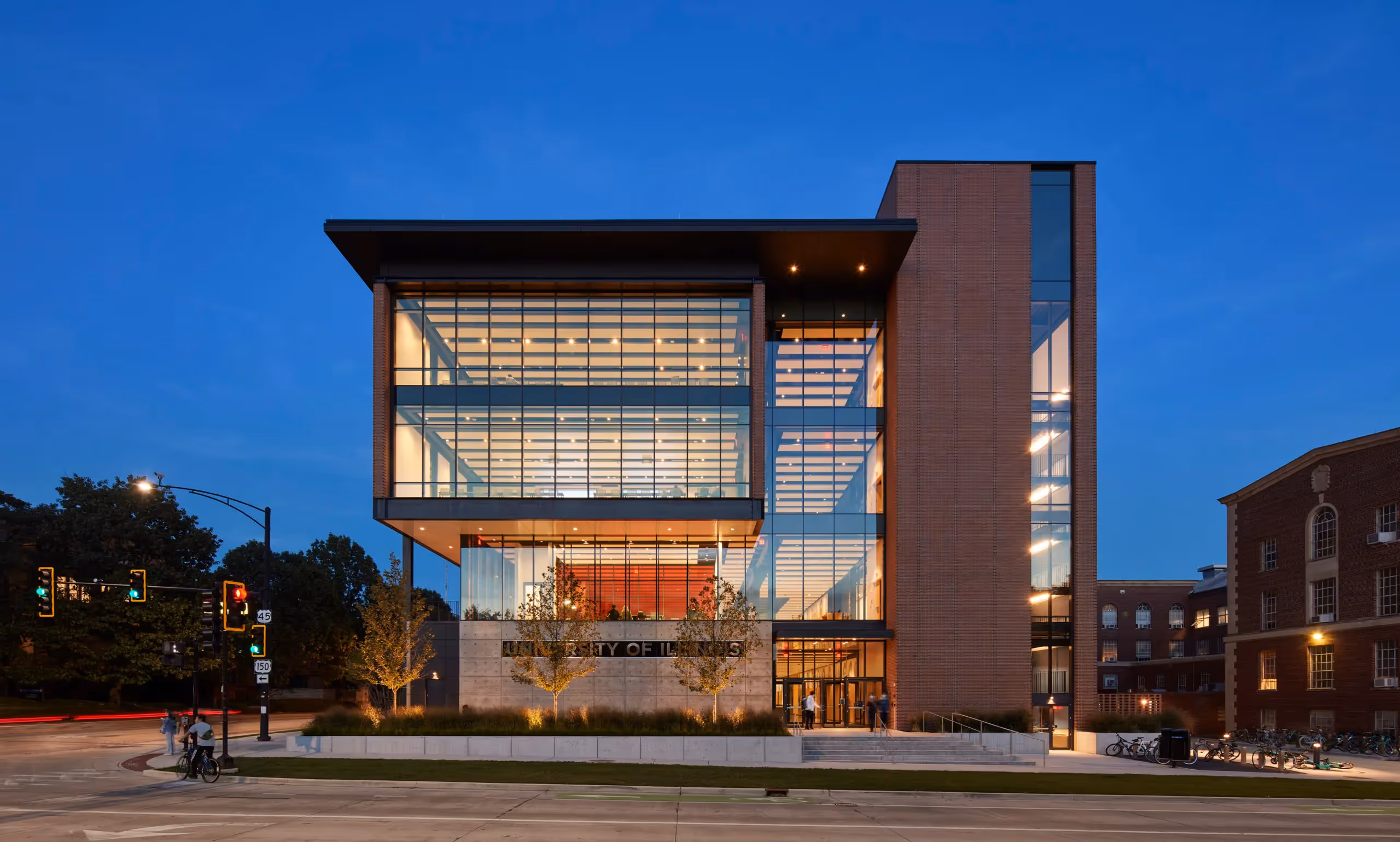 Picture of a building with a glass façade, UNIVERSTITY OF ILLINOIS is written on it.