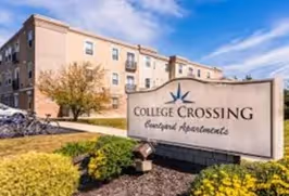 College crossing sign at campus entrance