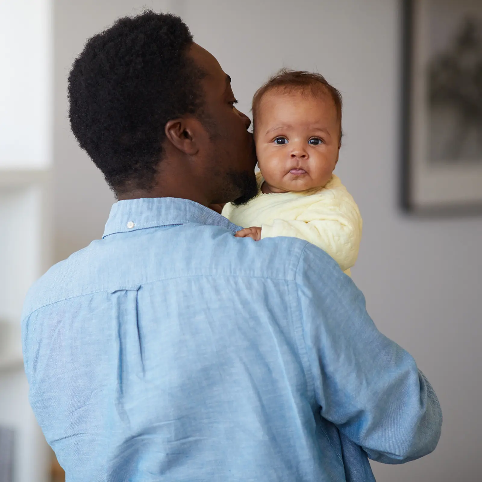 Father holding his baby, illustrating fathers' rights and parental responsibility under UK family law