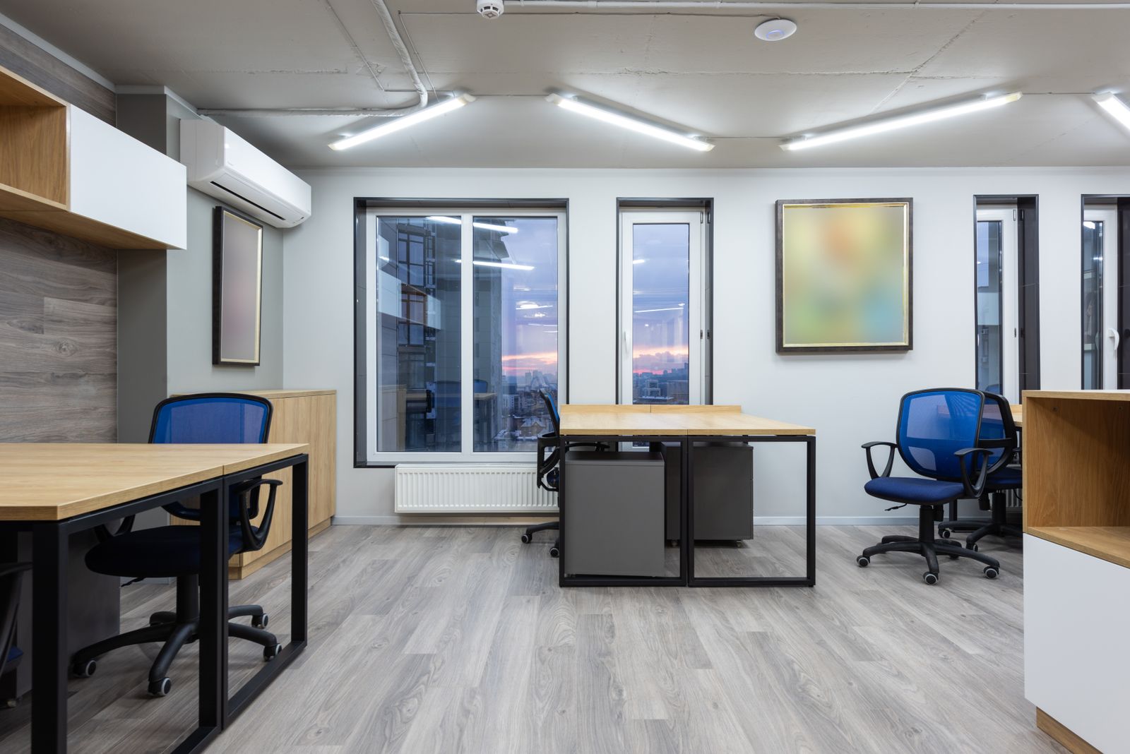 Bright, empty modern office with desks and chairs