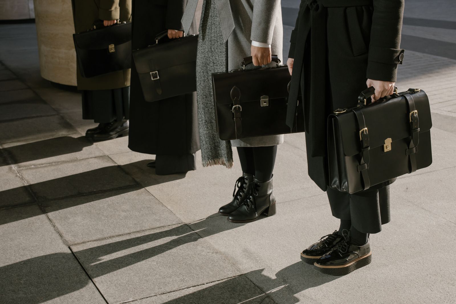 Business people carrying leather briefcases