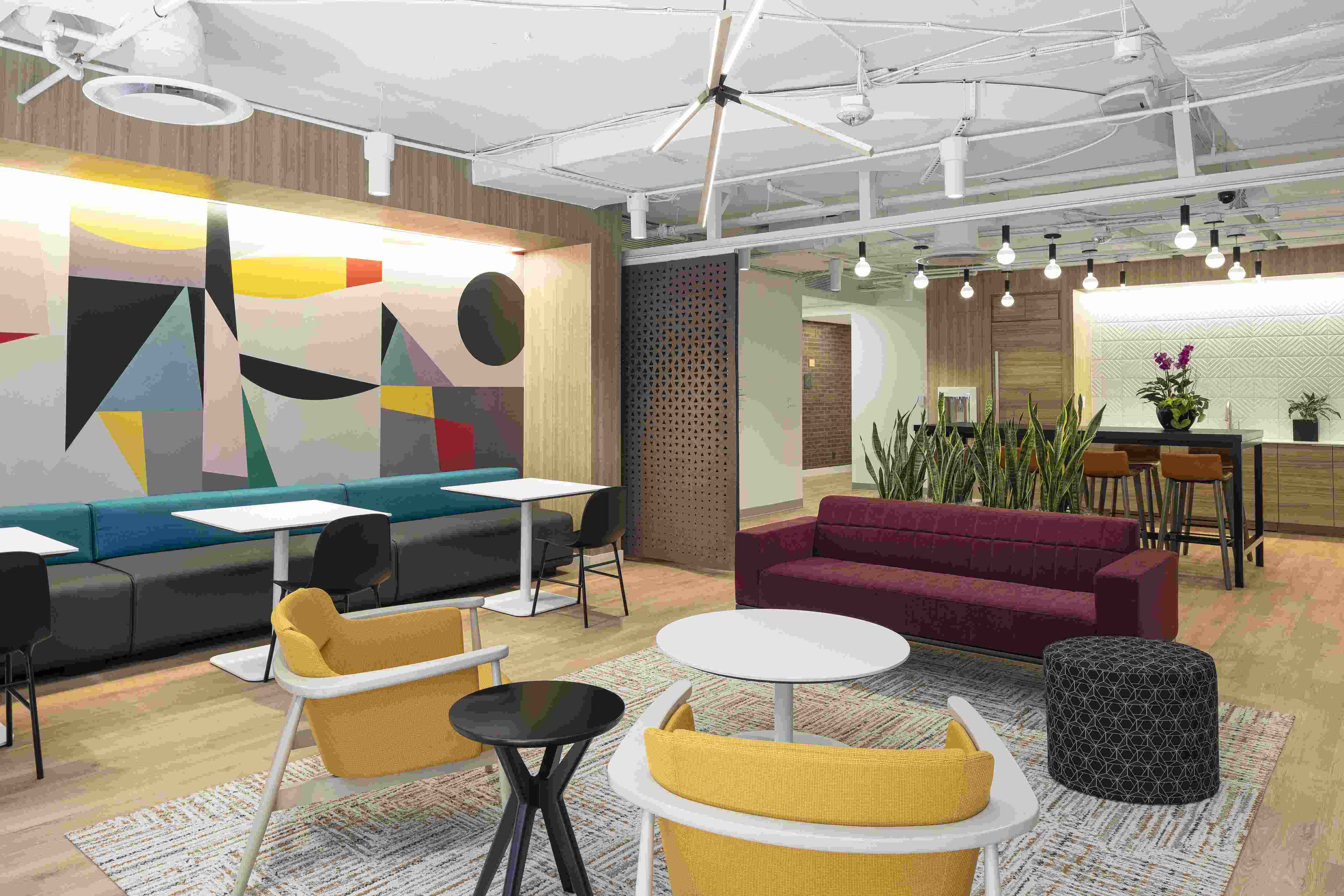 Office lobby with couch, chairs in different colors.