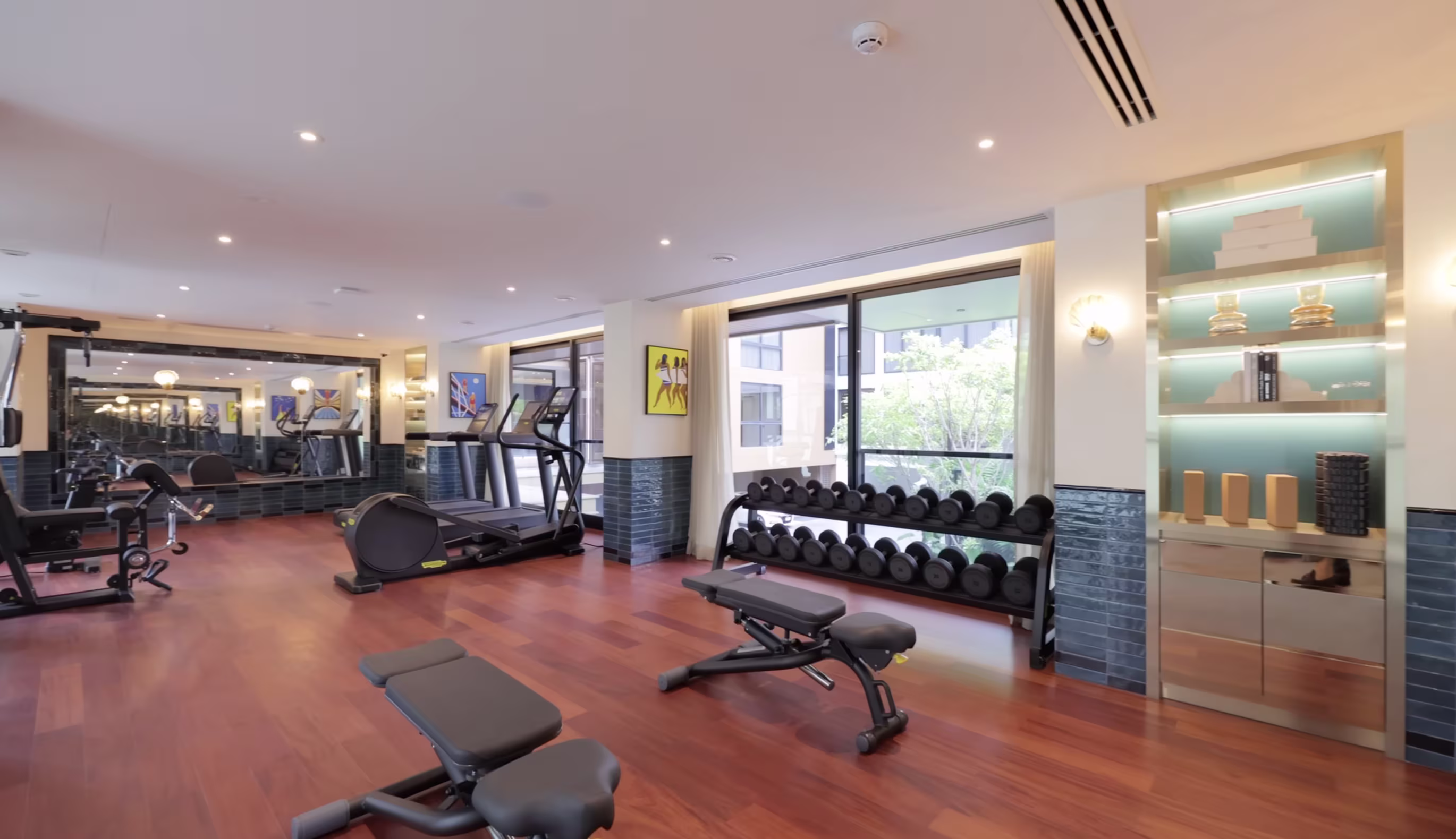 Via 34 gym with Technogym equipment and seashell lamps