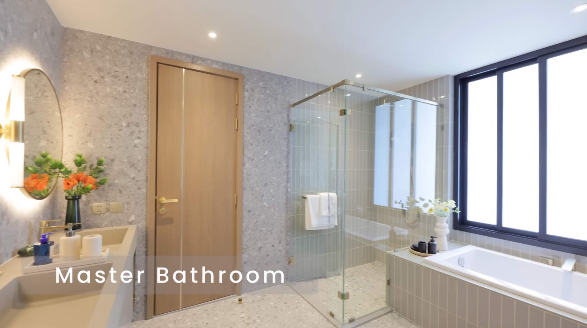 Master bathroom with bathtub, separate shower, and double sinks