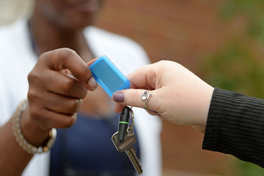 2 people handing over keys between them