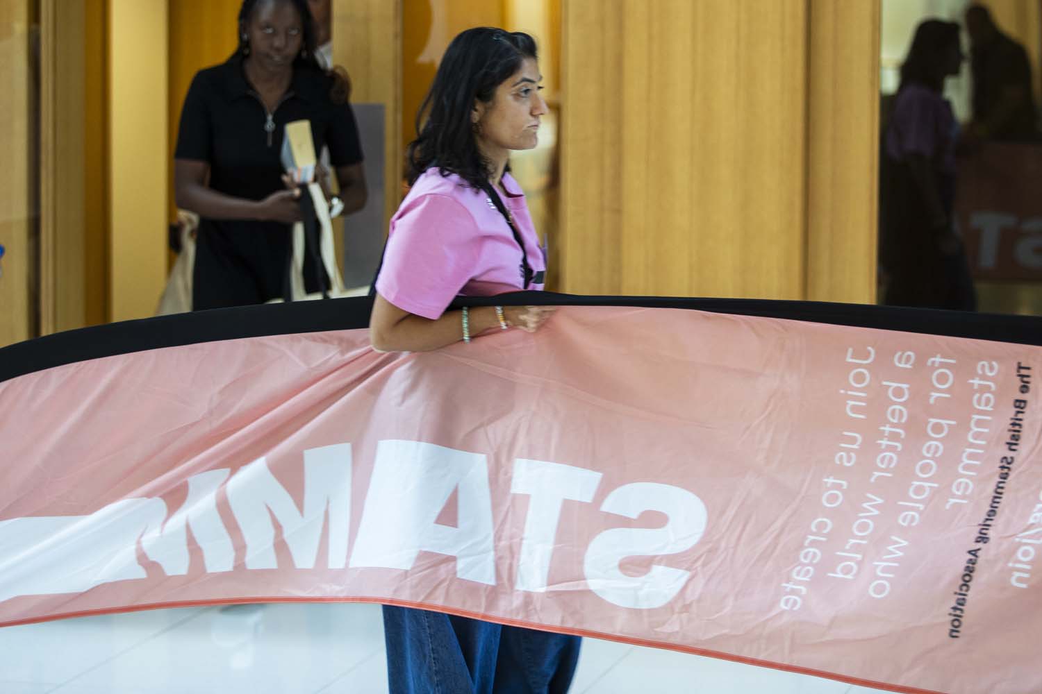 Pritie carrying STAMMA flag banner