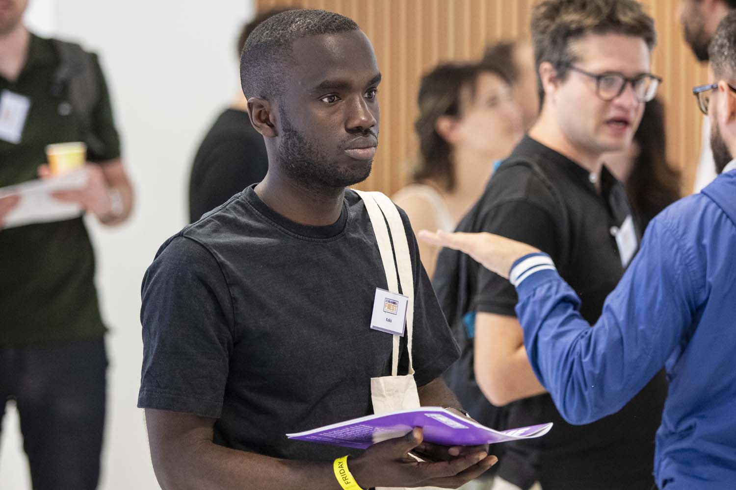 Young man holding programme