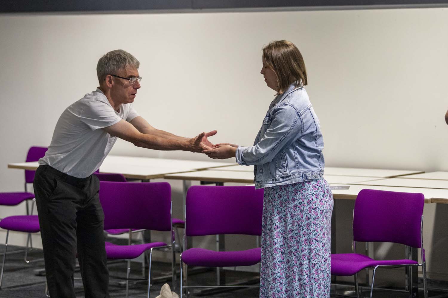 Workshop: John Russell holding Olivia's hands