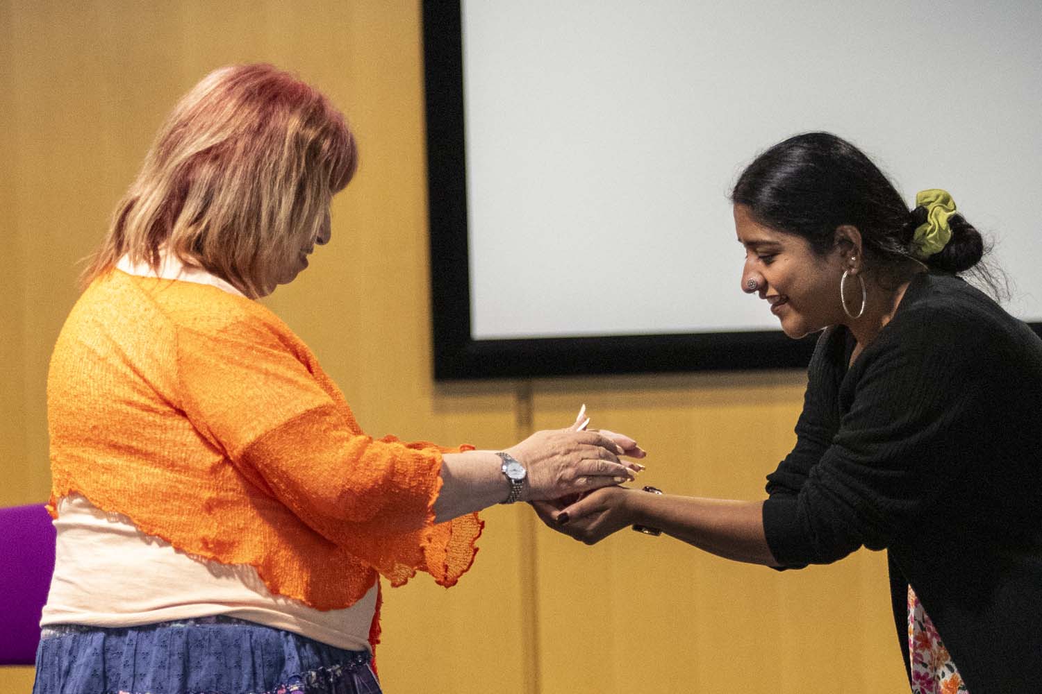 Workshop: Sharon Benson holding woman's hands