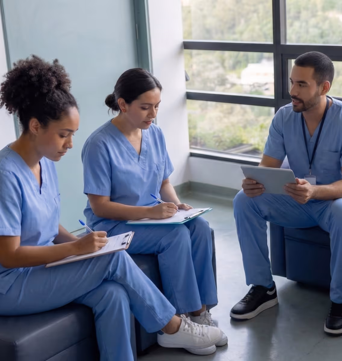 A group of medical workers sitting in a room.