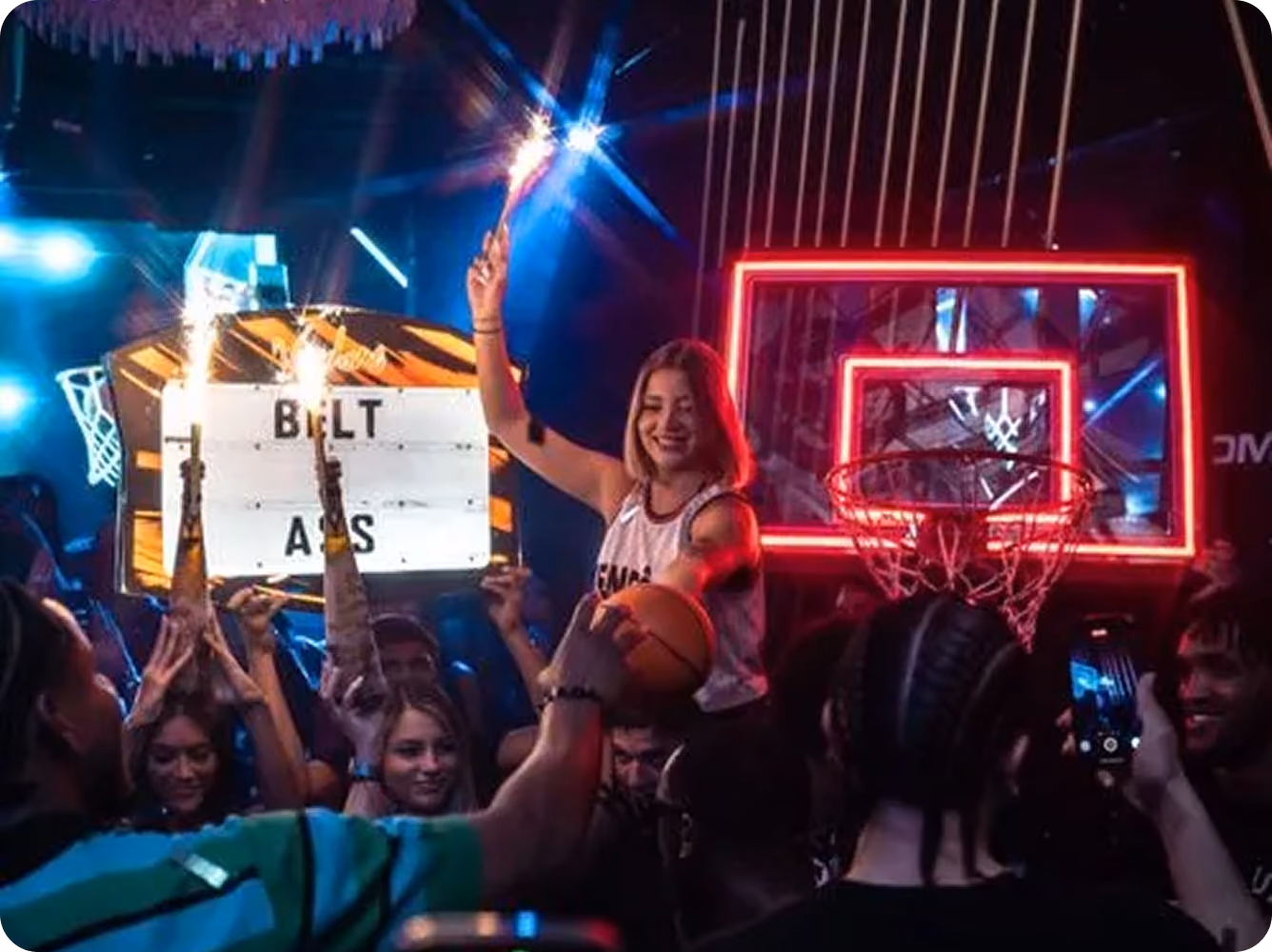 Guest lifted above the crowd with a sparkler at a private party at Vendôme Miami