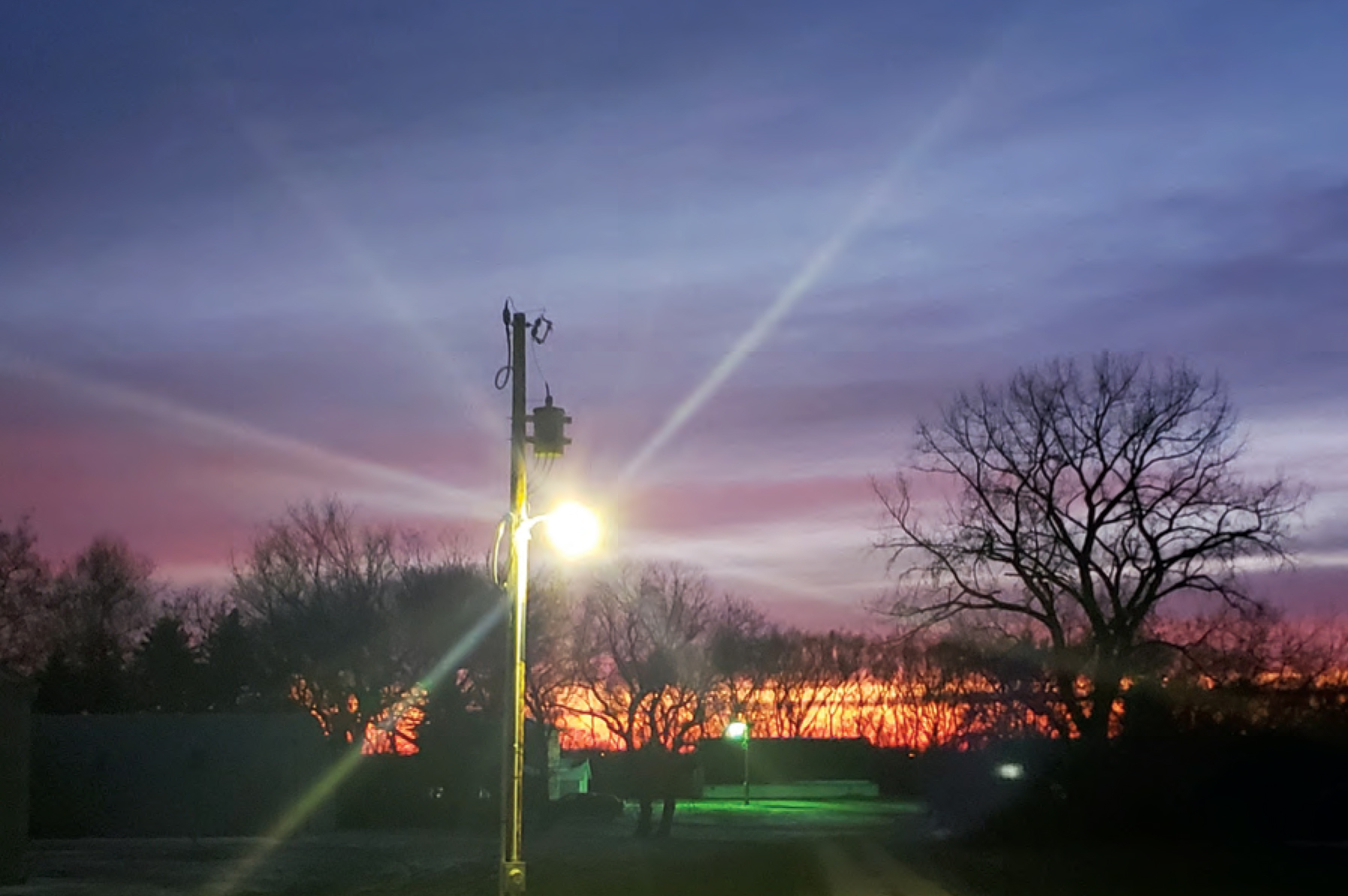 A yard light at sunset