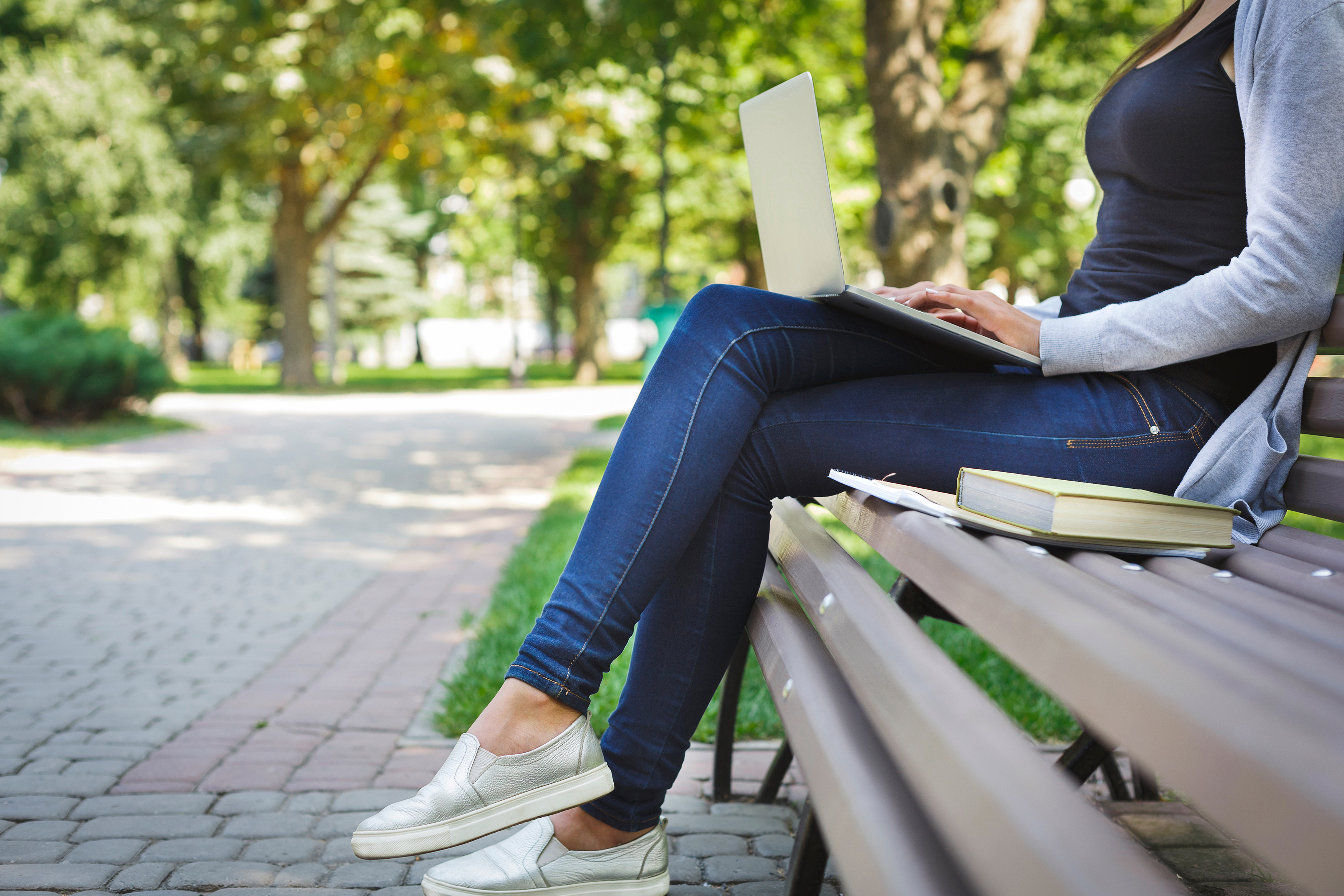 Person on a laptop sitting outside in nice weather