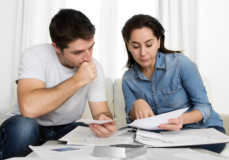 A younger couple looking at their finances