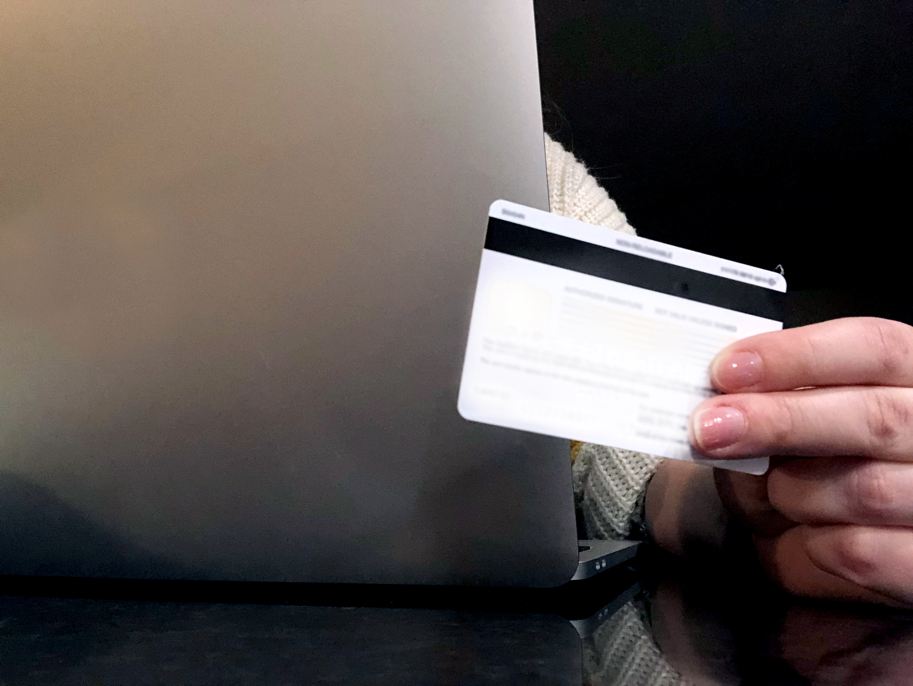 A hand holding a credit or debit card