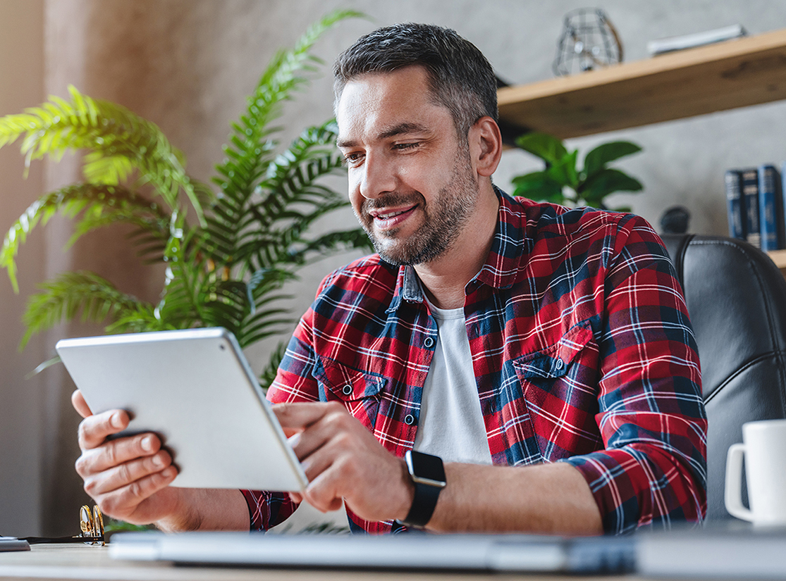 A young man looking at a tablet