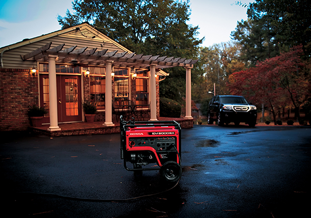 A home at night time with a generator in front of it
