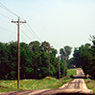 A 69-kV power line along a hilly road