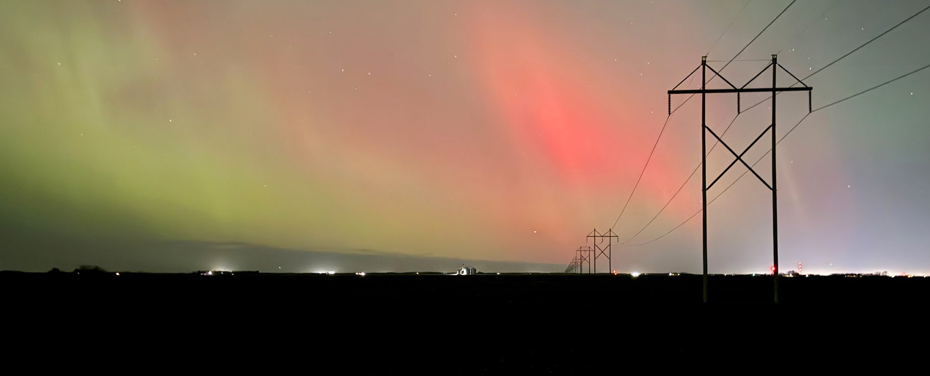 A 230-kV power line with the Northern Lights in the background