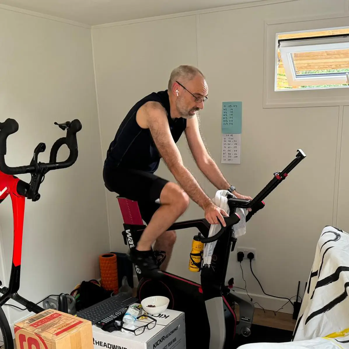 Cyclist riding a smart bike in a home training space.