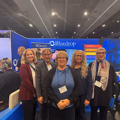 Group of delegates posing together on the trade show floor at a CADSI exhibition.