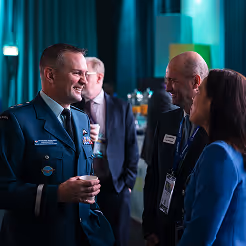 CADSI members networking at a defence industry event, shaking hands and exchanging ideas.