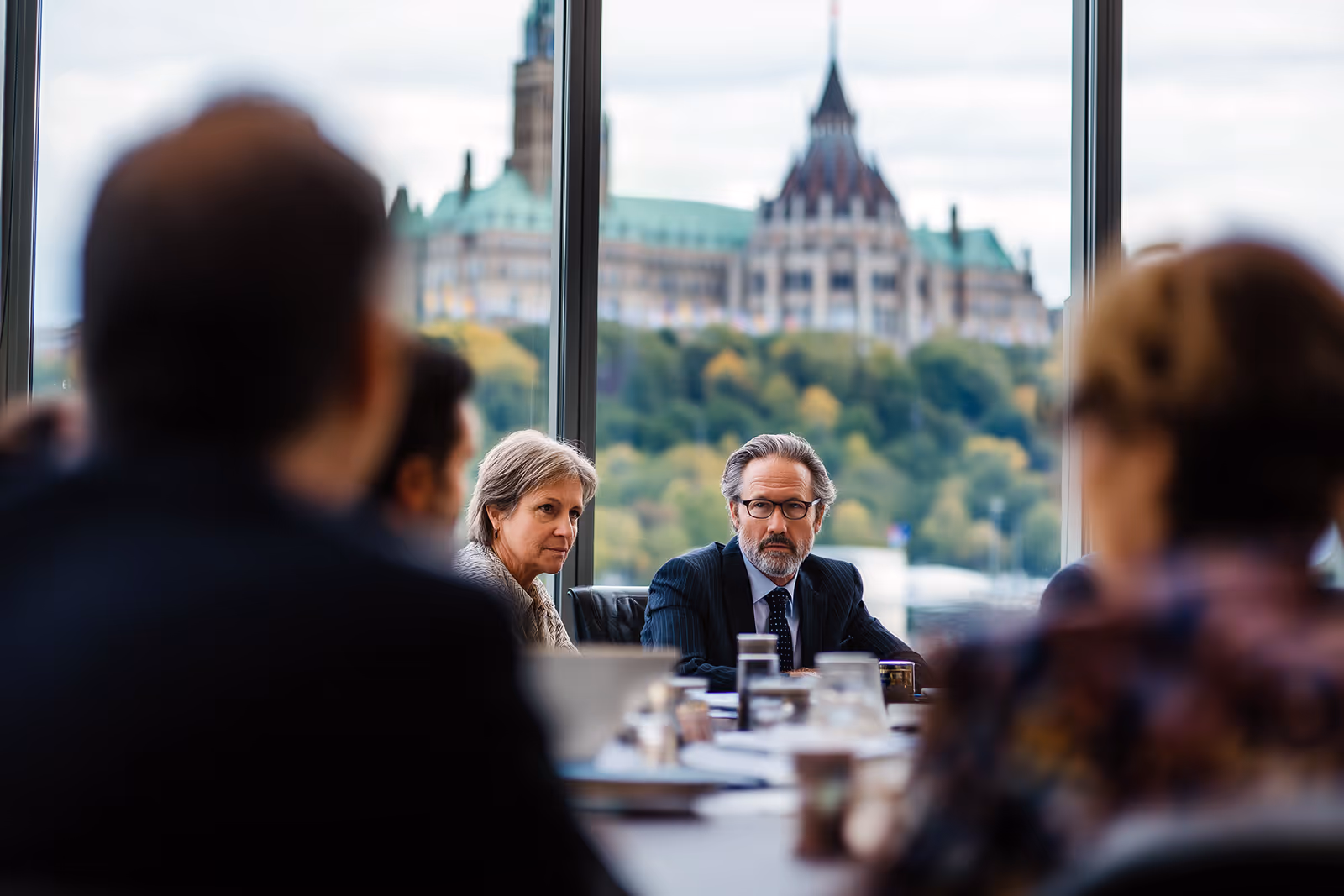 Industry leaders meeting with government officials in Ottawa overlooking the Parliament Buildings.