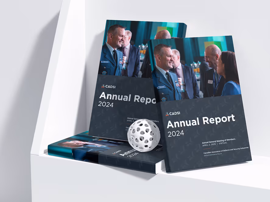 Open annual report books on a desk showing pages with photos and charts.