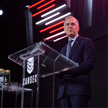 Government minister delivering a speech at the CANSEC podium during the opening ceremony.