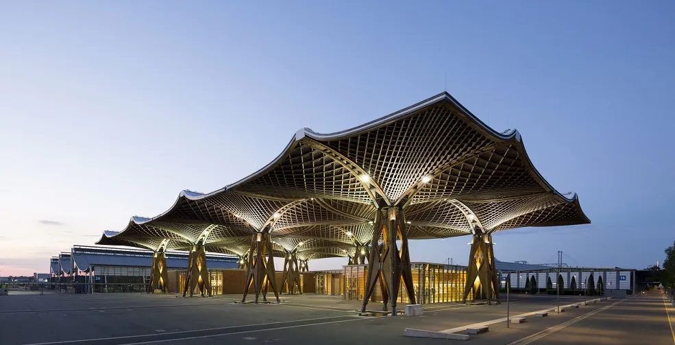 The illuminated Expo roof at Hannover Exhibition Grounds at dusk.