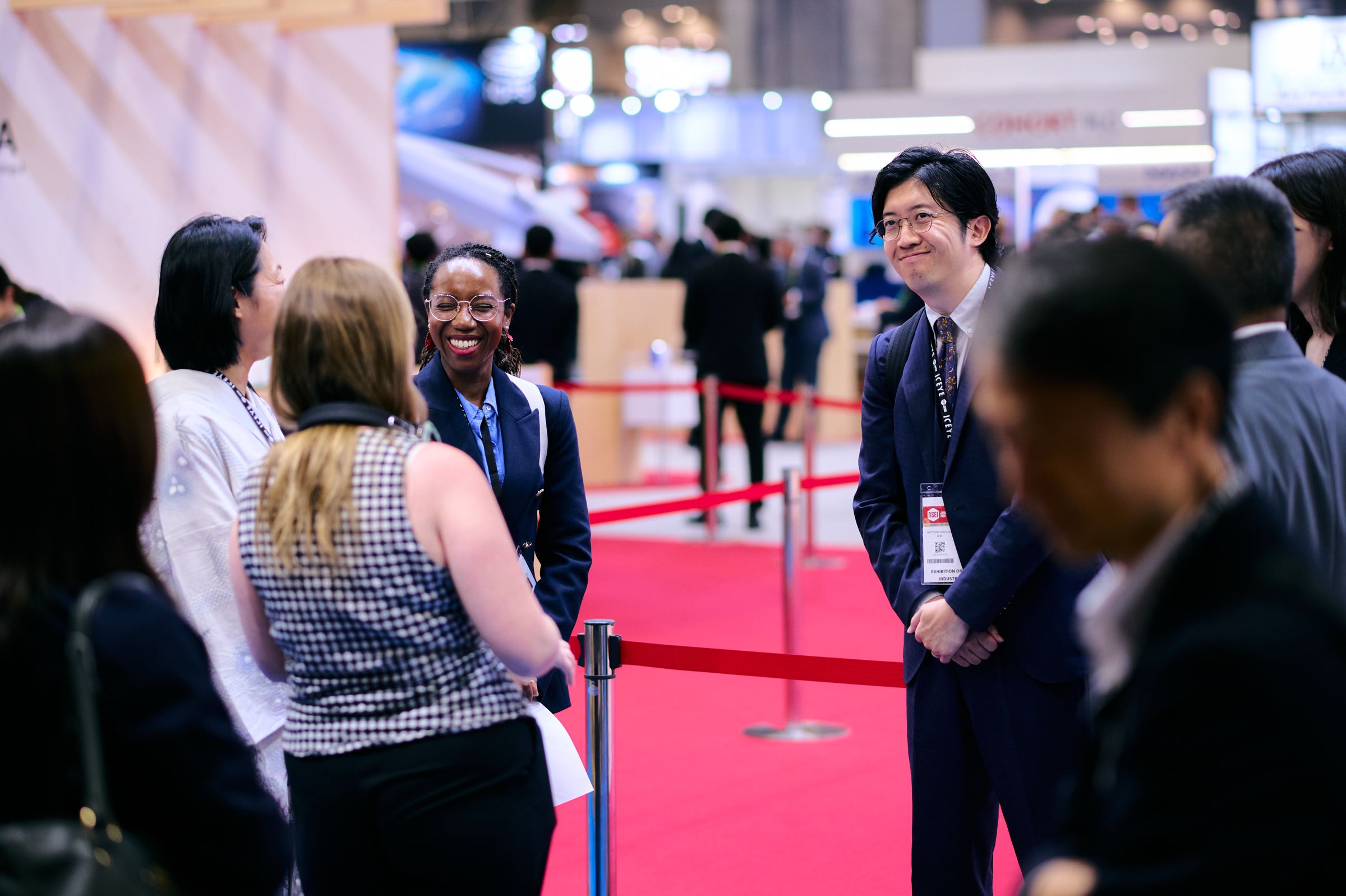Two people in conversation on the exhibition floor at DSEI Japan 2025.