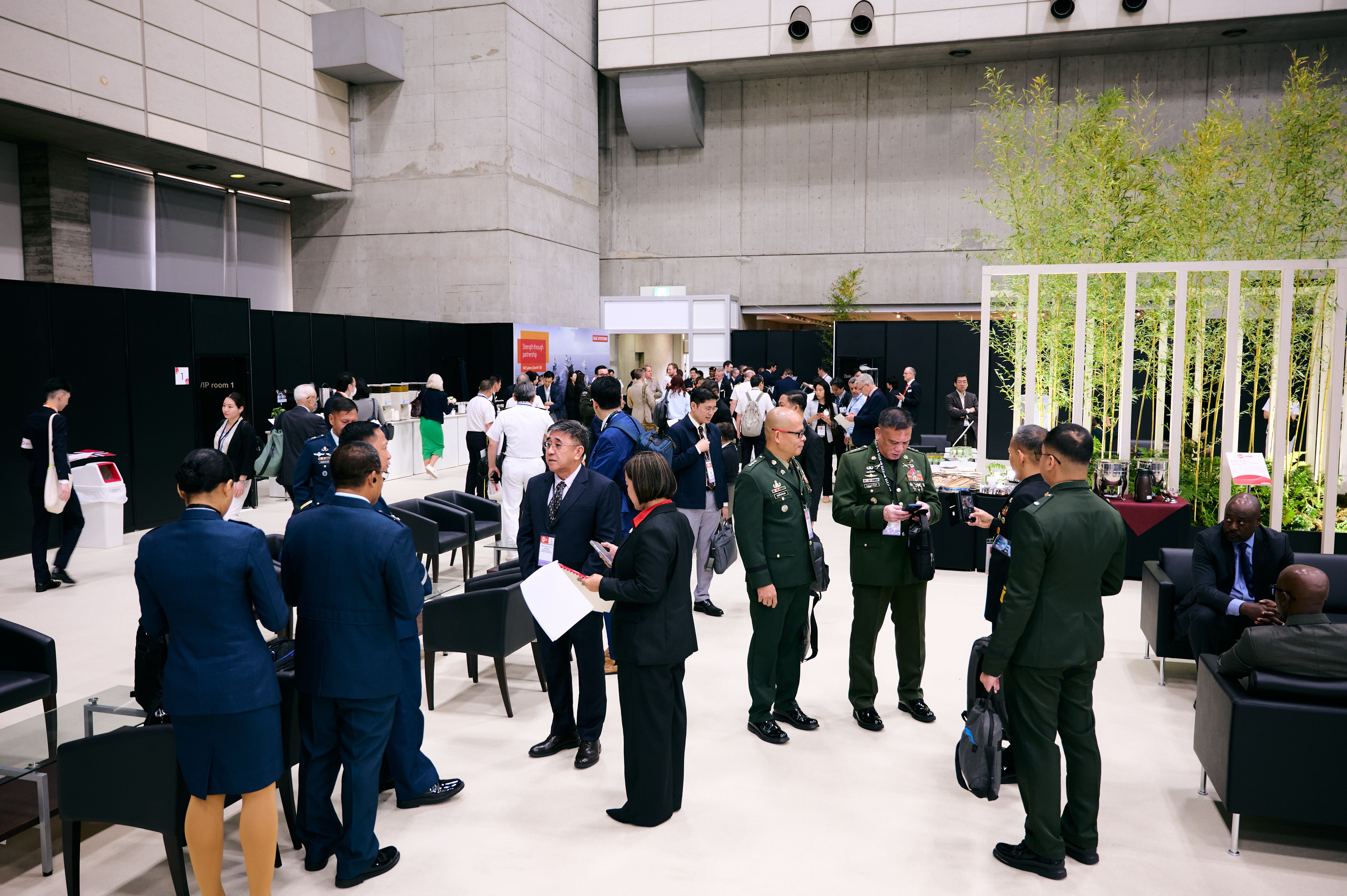 A networking conversation at DSEI Japan 2025.