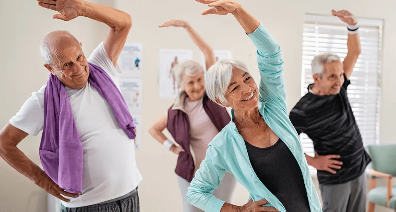 Active seniors doing gentle stretching with flexibility after artificial disc replacement guided by the best spine surgeon in Los Angeles.