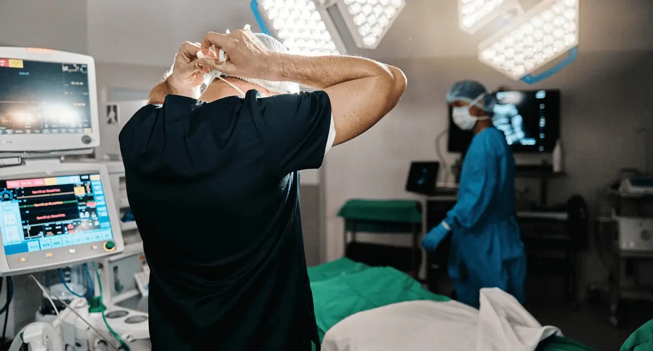 Surgeons preparing an operating room with advanced medical equipment, representing expert spinal procedures performed by the best spine surgeon in Los Angeles.