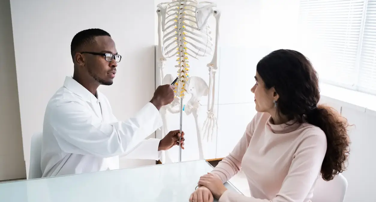 Medical illustration of the cervical spine showing vertebrae and discs in the neck