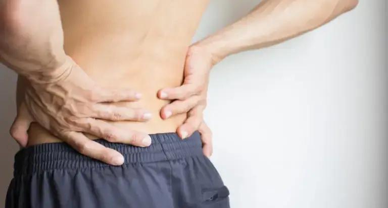 Person twisting at the waist to crack their lower back while sitting