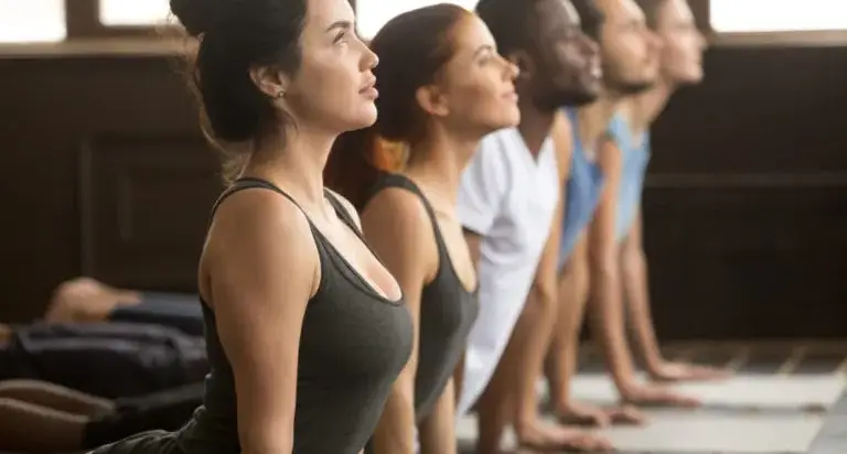 Person doing a gentle seated spinal stretch to relieve mid-back and lower back stiffness