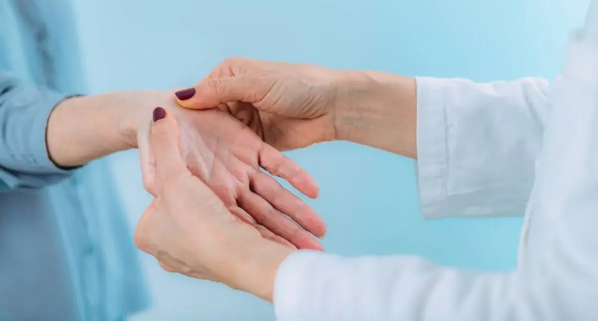 Clinician examining a patient’s wrist and hand during a carpal tunnel evaluation in Los Angeles