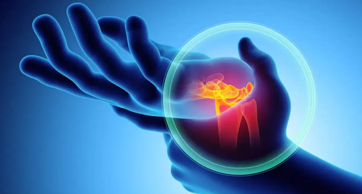 Teen holding their wrist and hand after tingling and numbness, possible signs of carpal tunnel syndrome