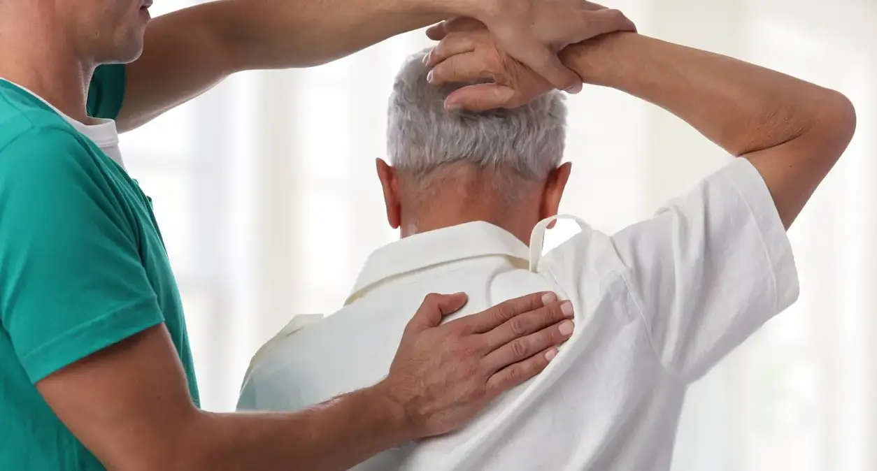 Person doing a gentle knee-to-chest stretch for pinched nerve symptoms in the lower back